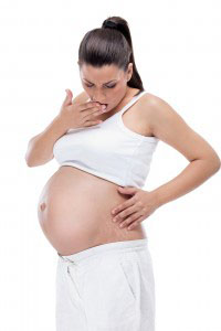 Pregnant woman looking at stretch marks